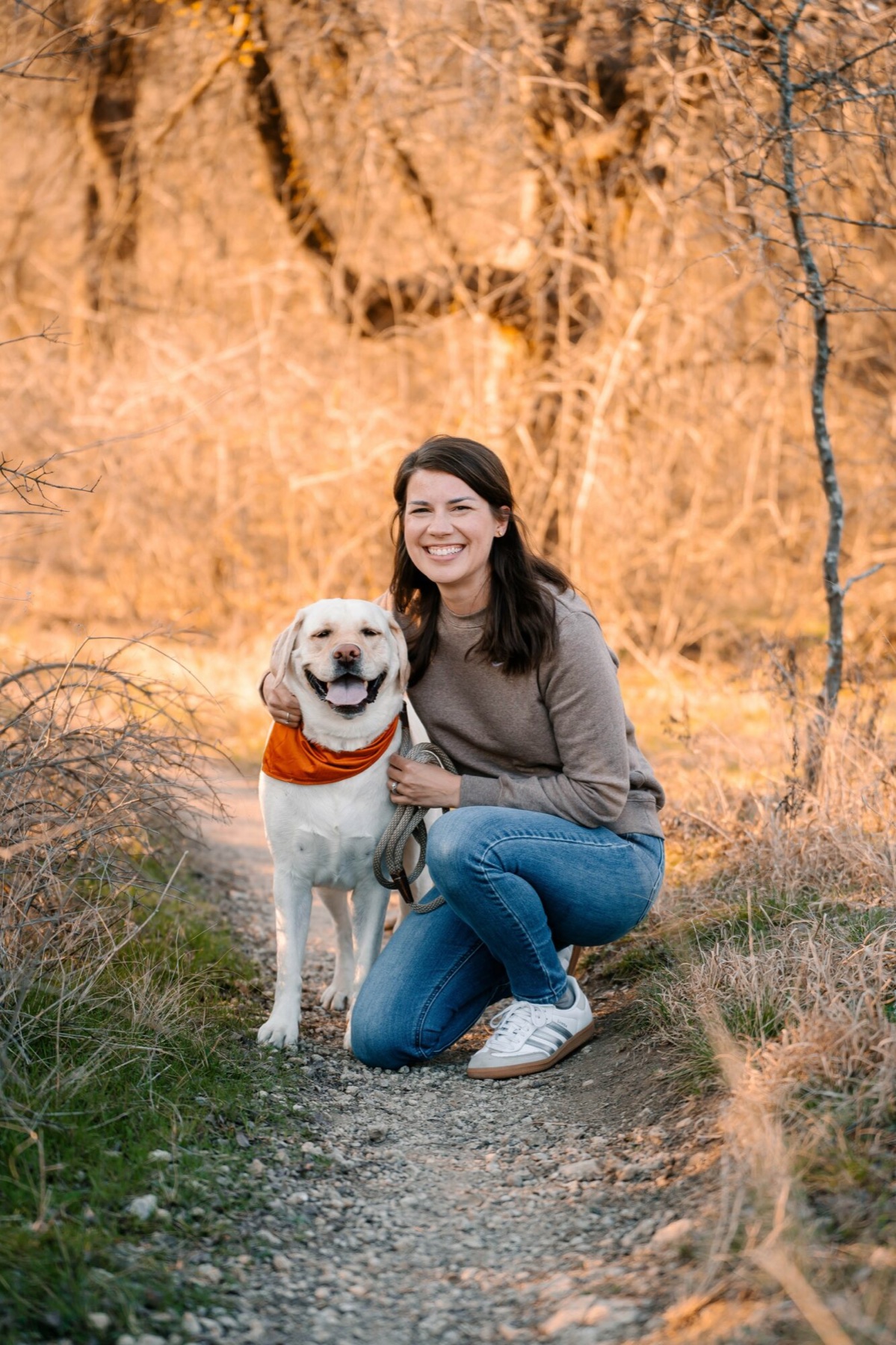 Sara Wright, owner of Aledo Pet Sitting, with a yellow Labrador on an Aledo trail